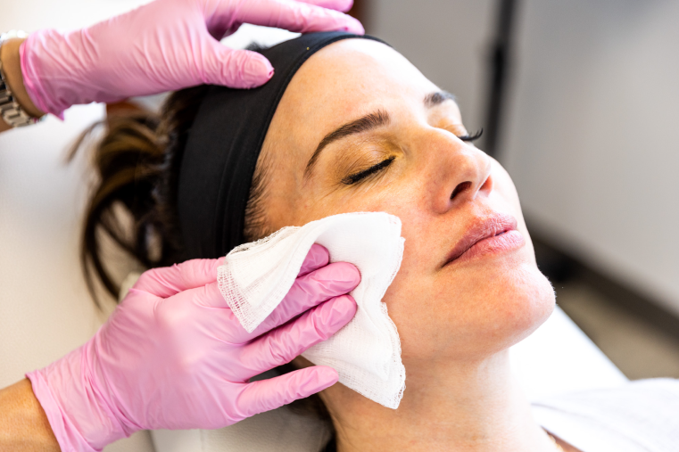 A woman's face is being wiped with a cloth after a skin care treatment near pittsburgh