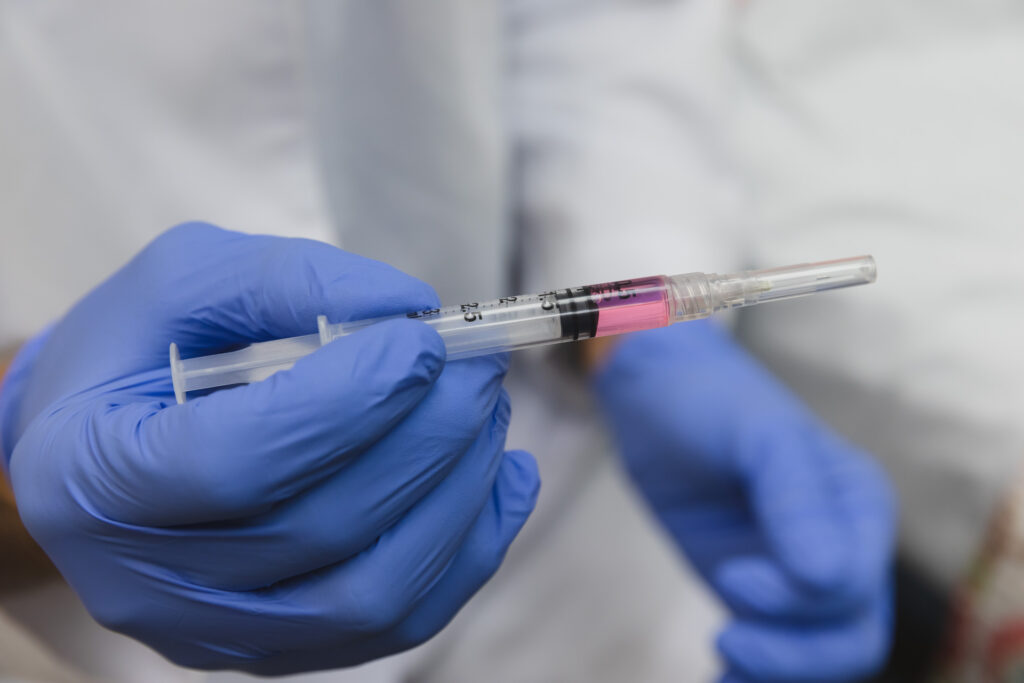 Close up of gloved hands holding a syringe for Medical Weight Loss in Pittsburgh